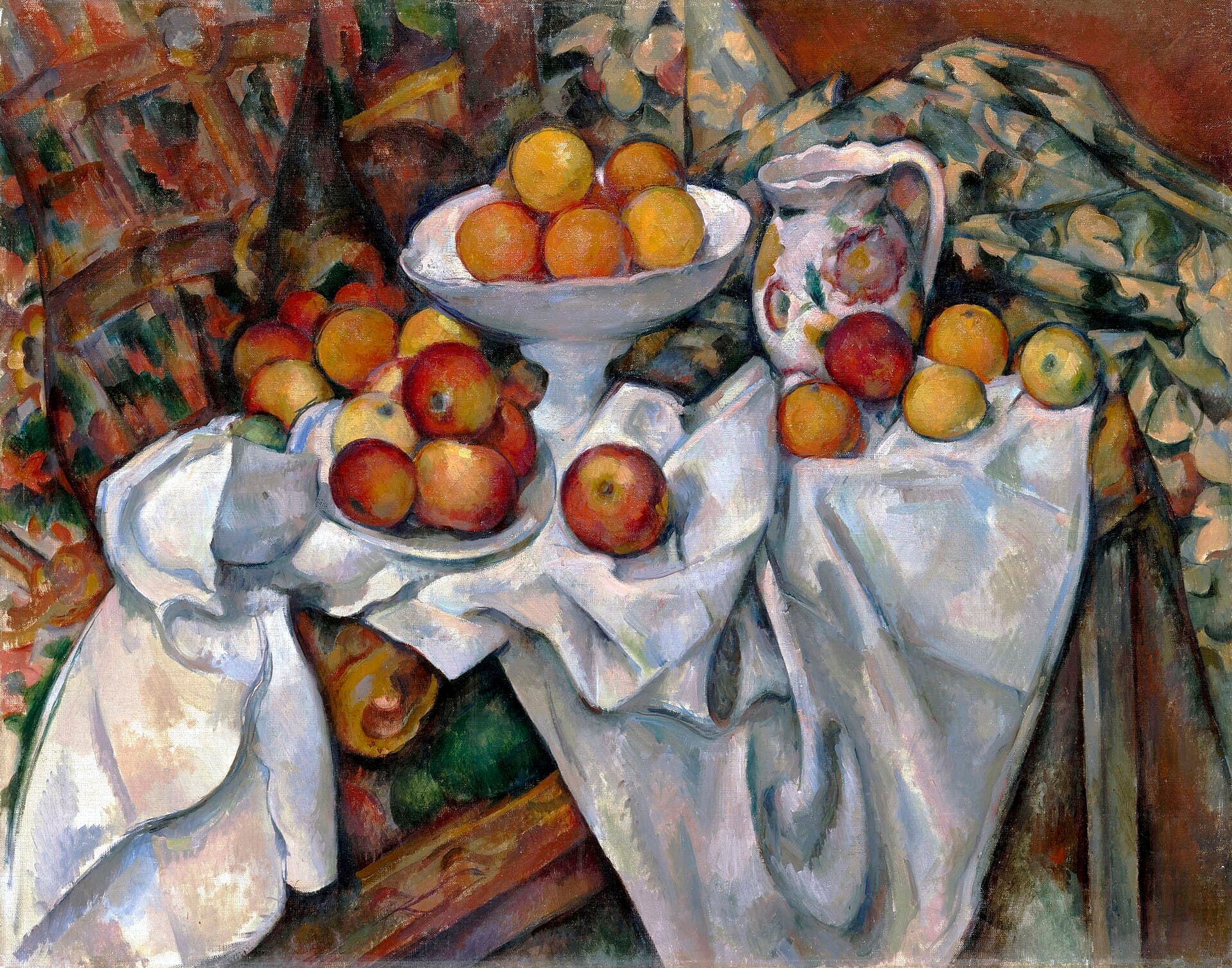 Abundant apples and oranges piled on rumpled white drapery